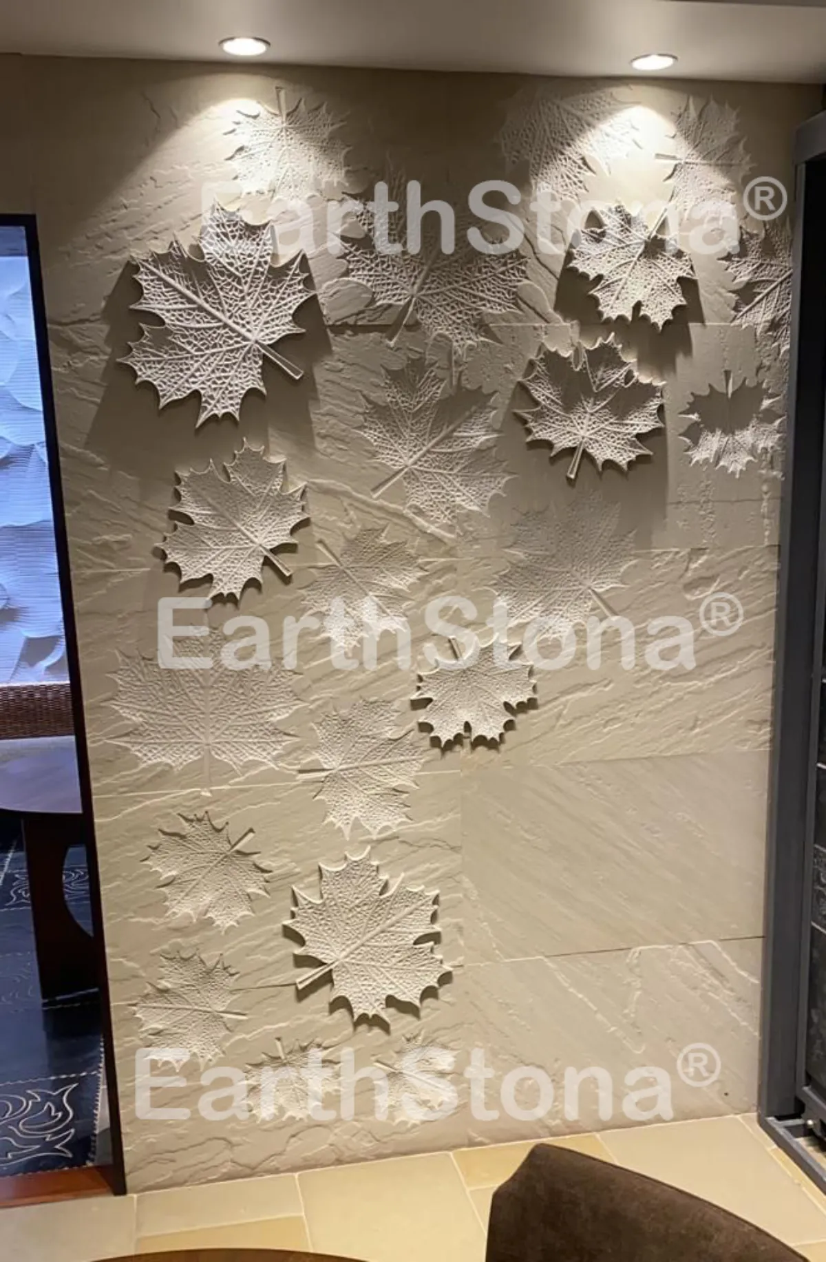 Mapple leaf with light on natural stone wall carving art